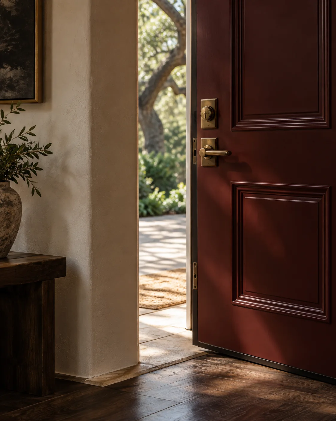 Illustrative burgundy entry door with brass hardware